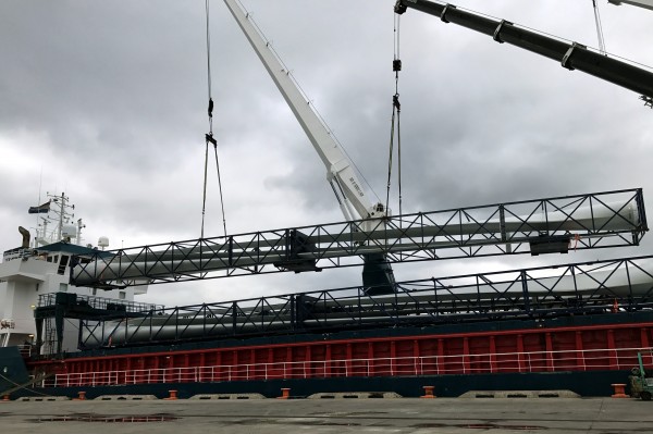 Cages containing a trio of 45-meter-long wind turbine blades from Spain are discharged at Delaware’s Port of Wilmington, which has been enjoying strong project cargo activity.